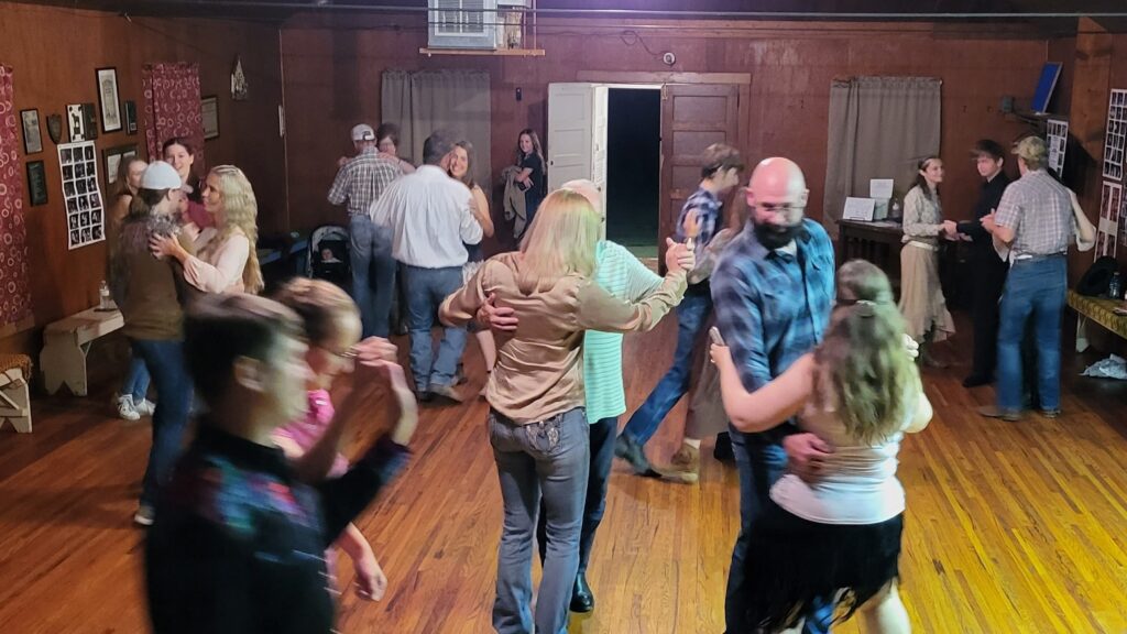 a group of couples dancing on a hardwood floor