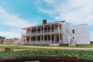 a large historic white house in front of a blue sky