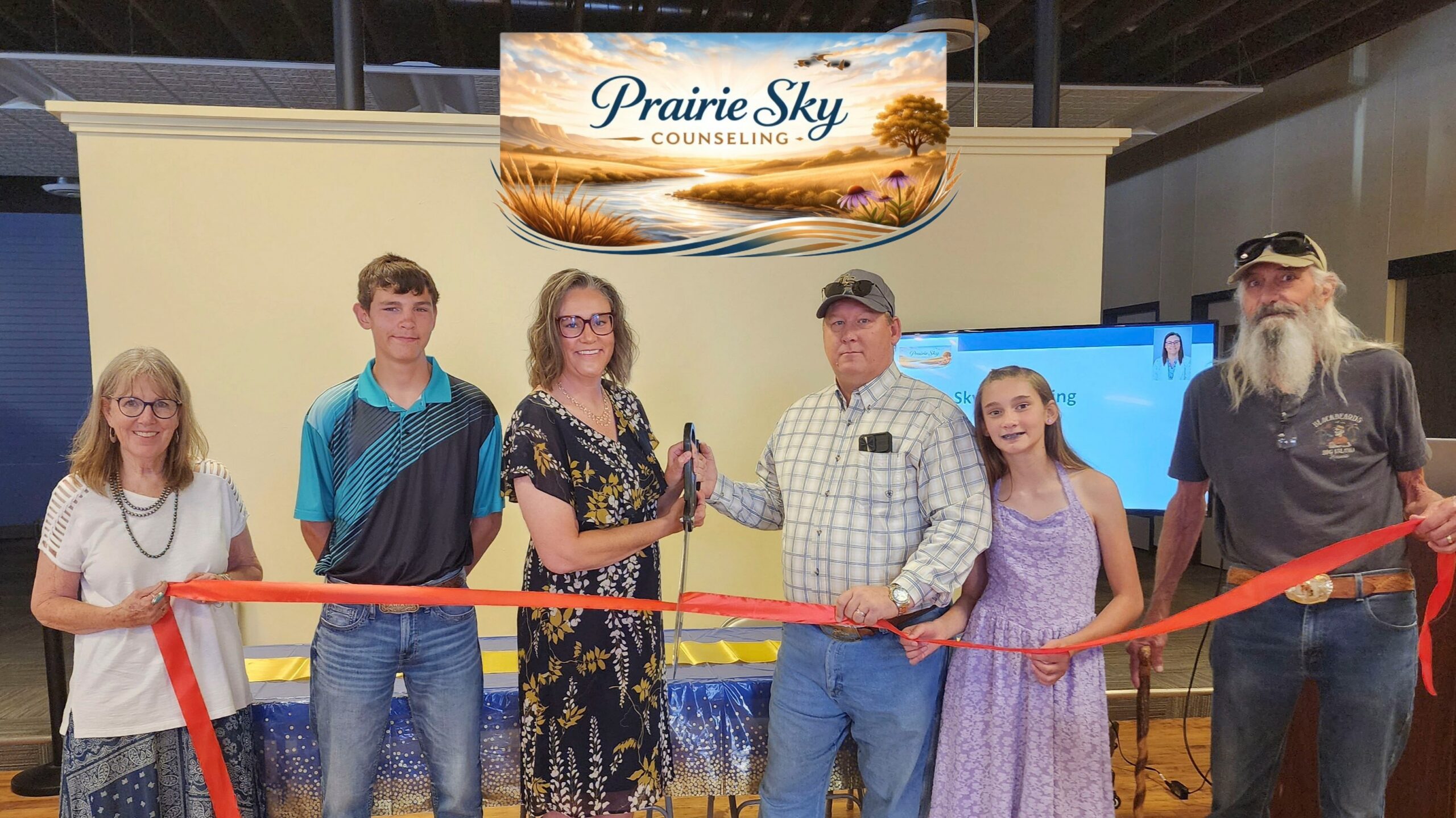 Prairie Sky Counseling owner Virginia Garrett celebrates the business’s ribbon cutting with family and community members in Torrington, Wyoming.